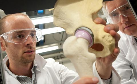 Staff members work on hip replacement